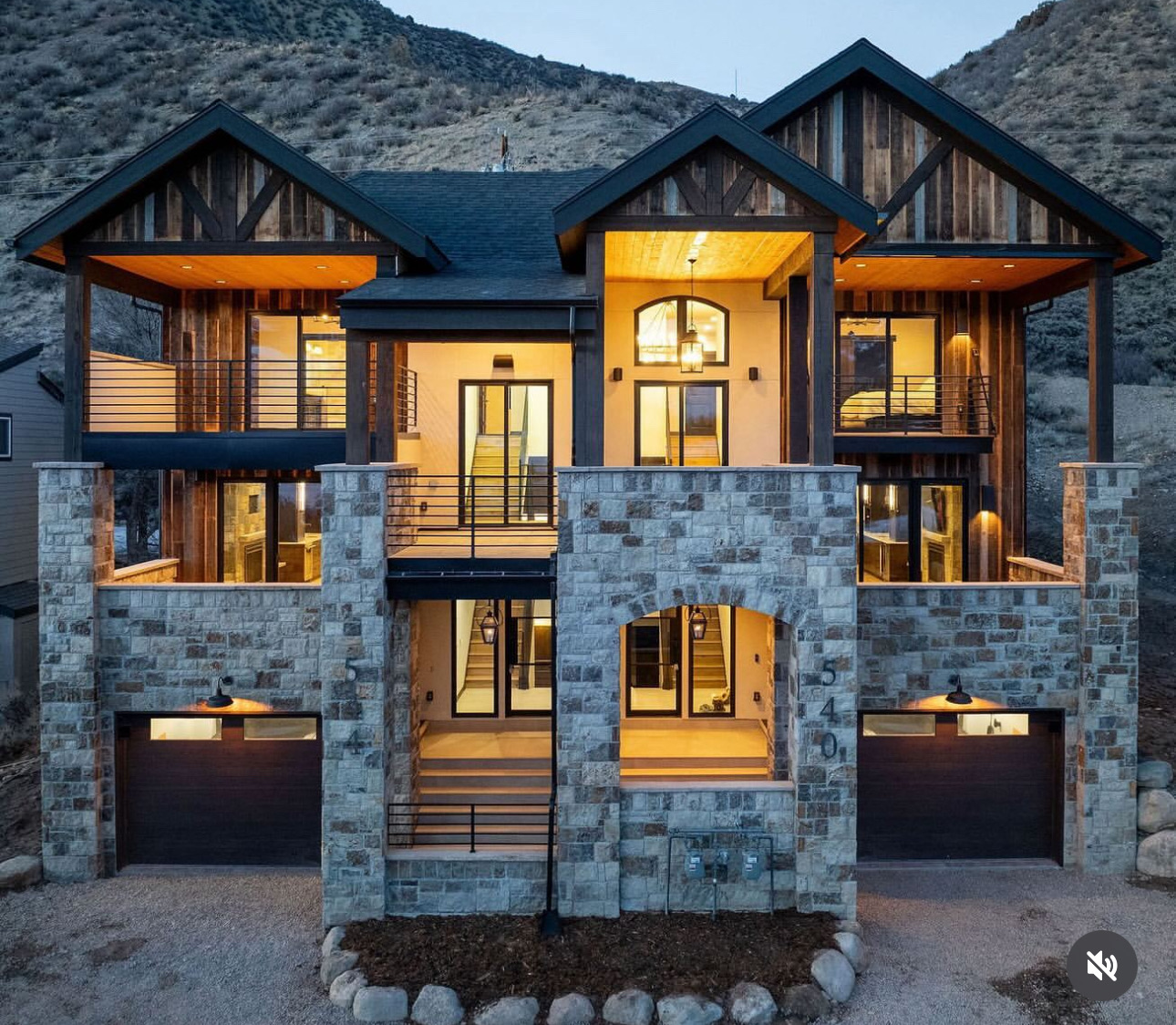 Front facade with reclaimed wood gables and stone base