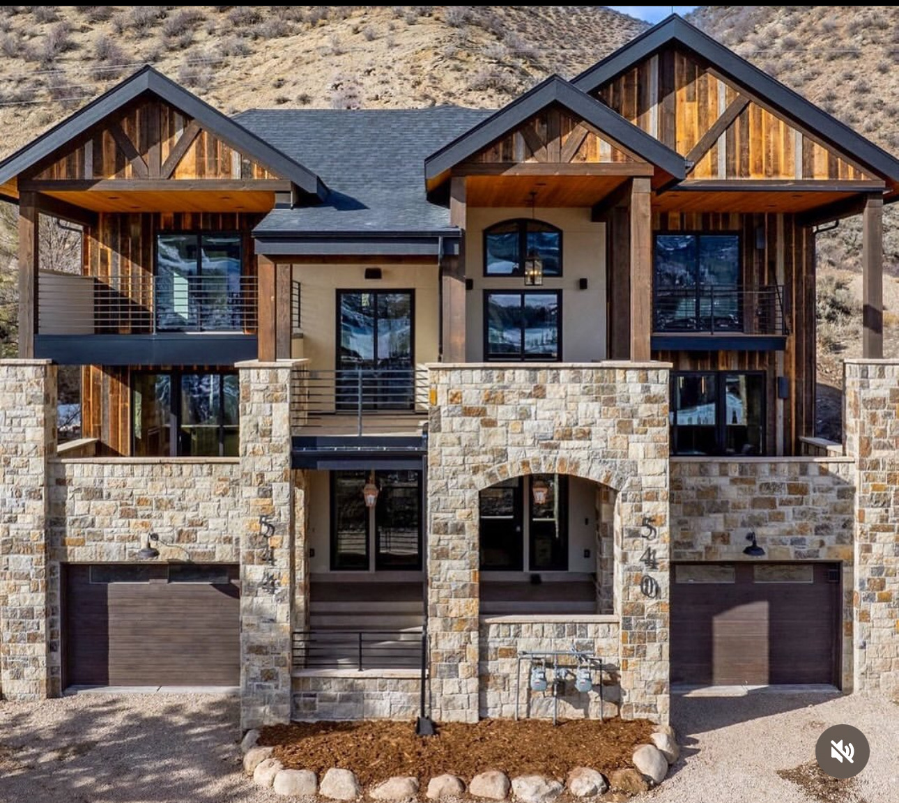 Daytime view of barn-wood-clad mountain residence