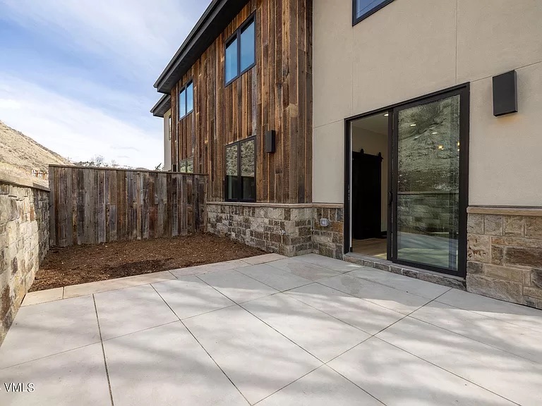 Patio with reclaimed barn wood exterior wall and fence