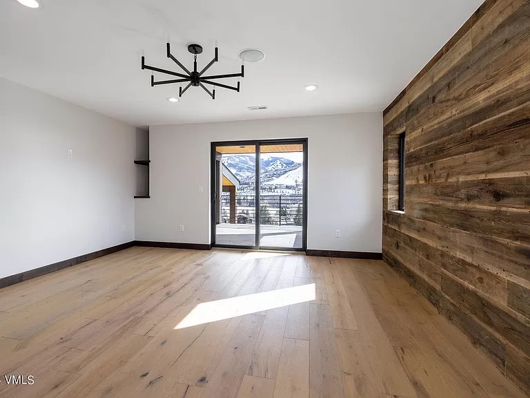 Interior accent wall in reclaimed barn wood with hardwood floors