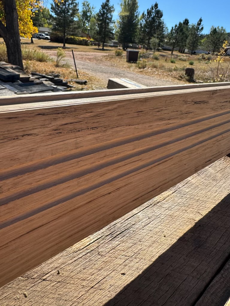 Rich brown milled reclaimed trim board with smooth face and dark streaking