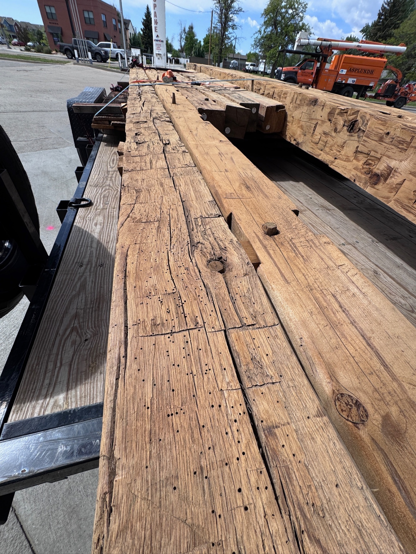 Stack of weathered boards with nail holes