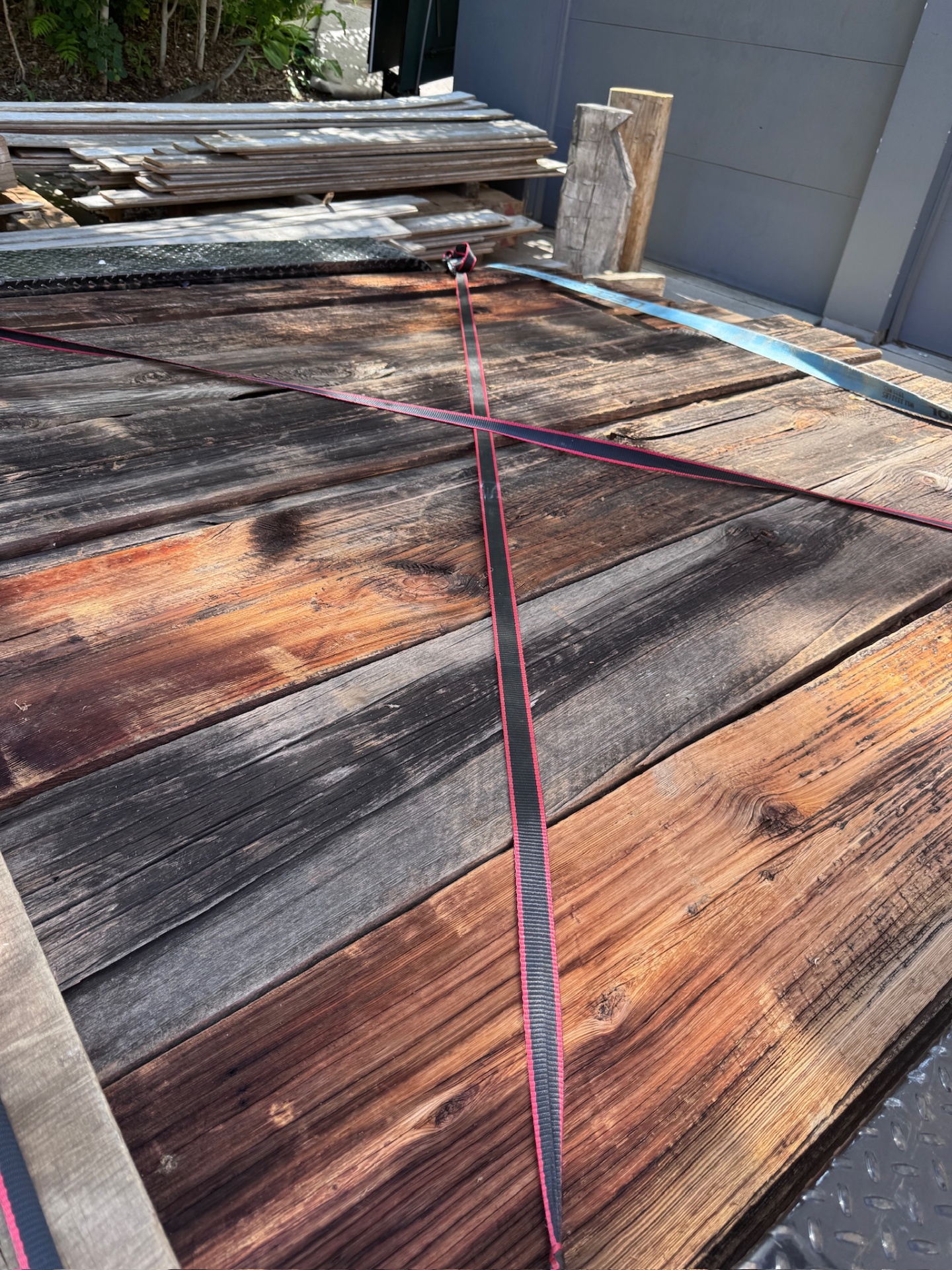 Weathered barn boards strapped down for delivery