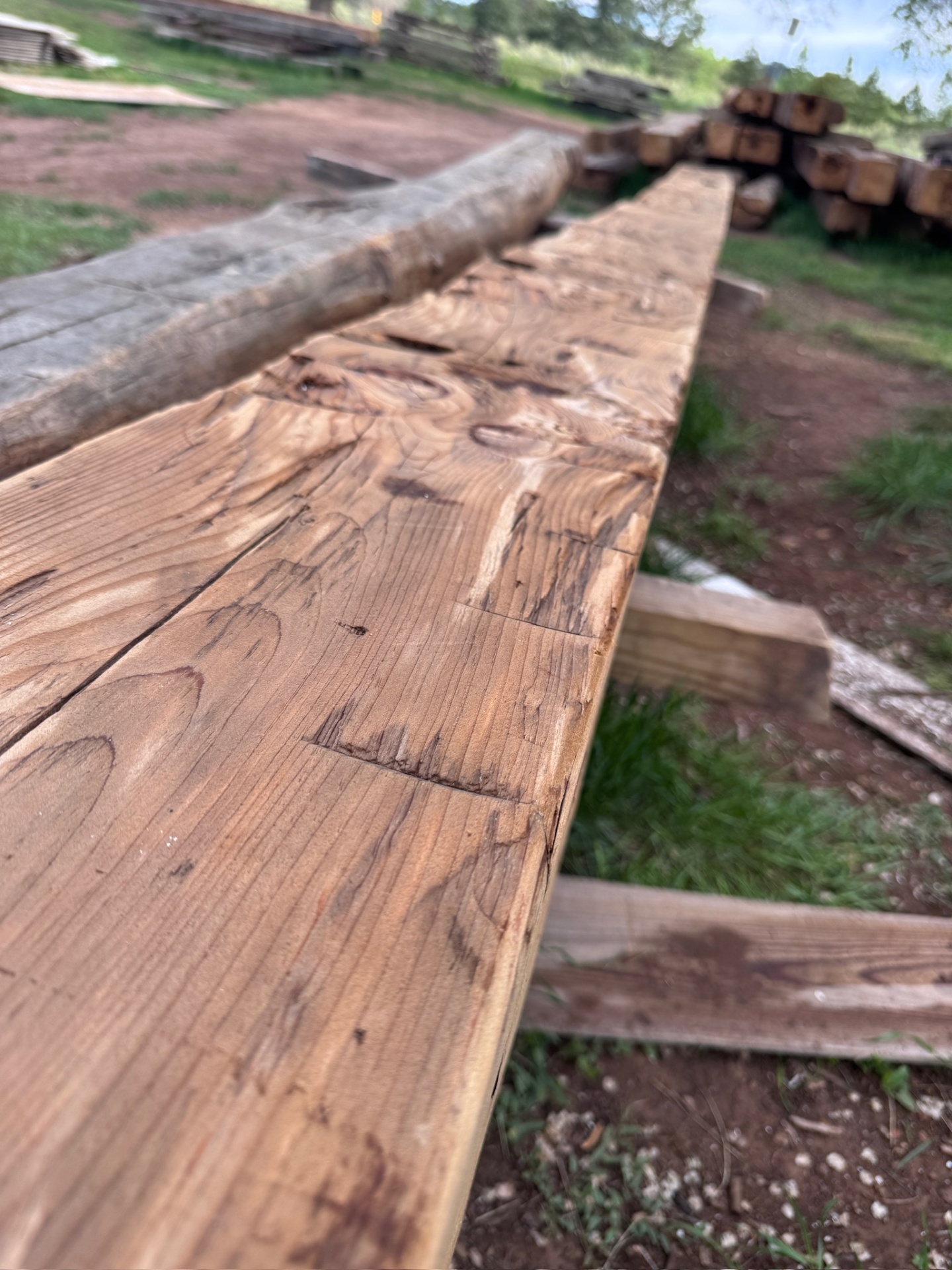 Long beam with hewn surface in the yard
