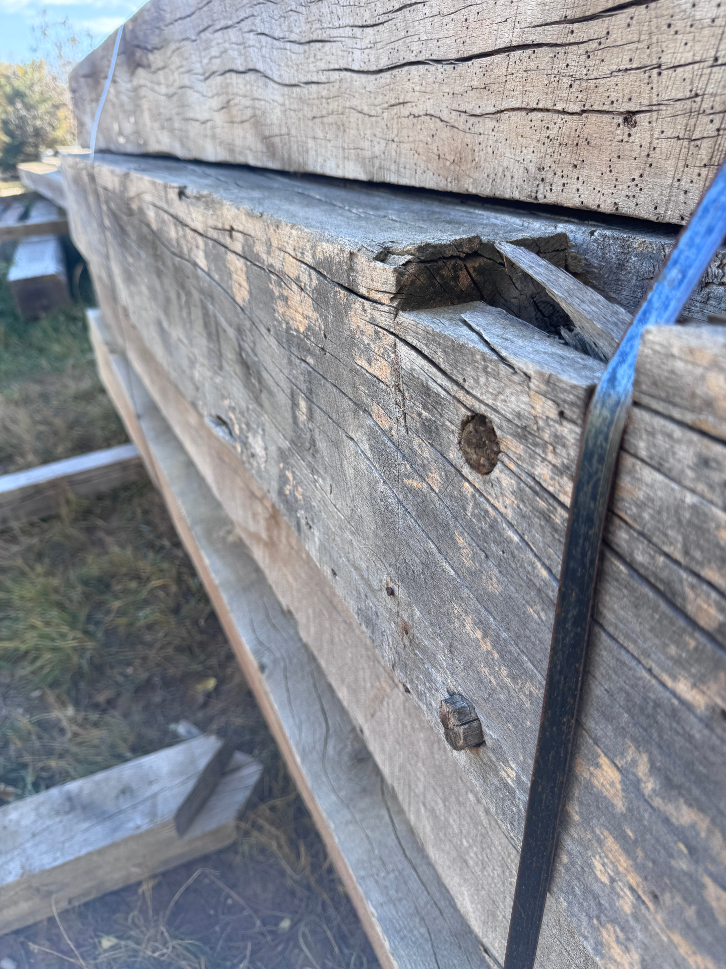 Close-up of rough sawn reclaimed beam with split corner and weathered face