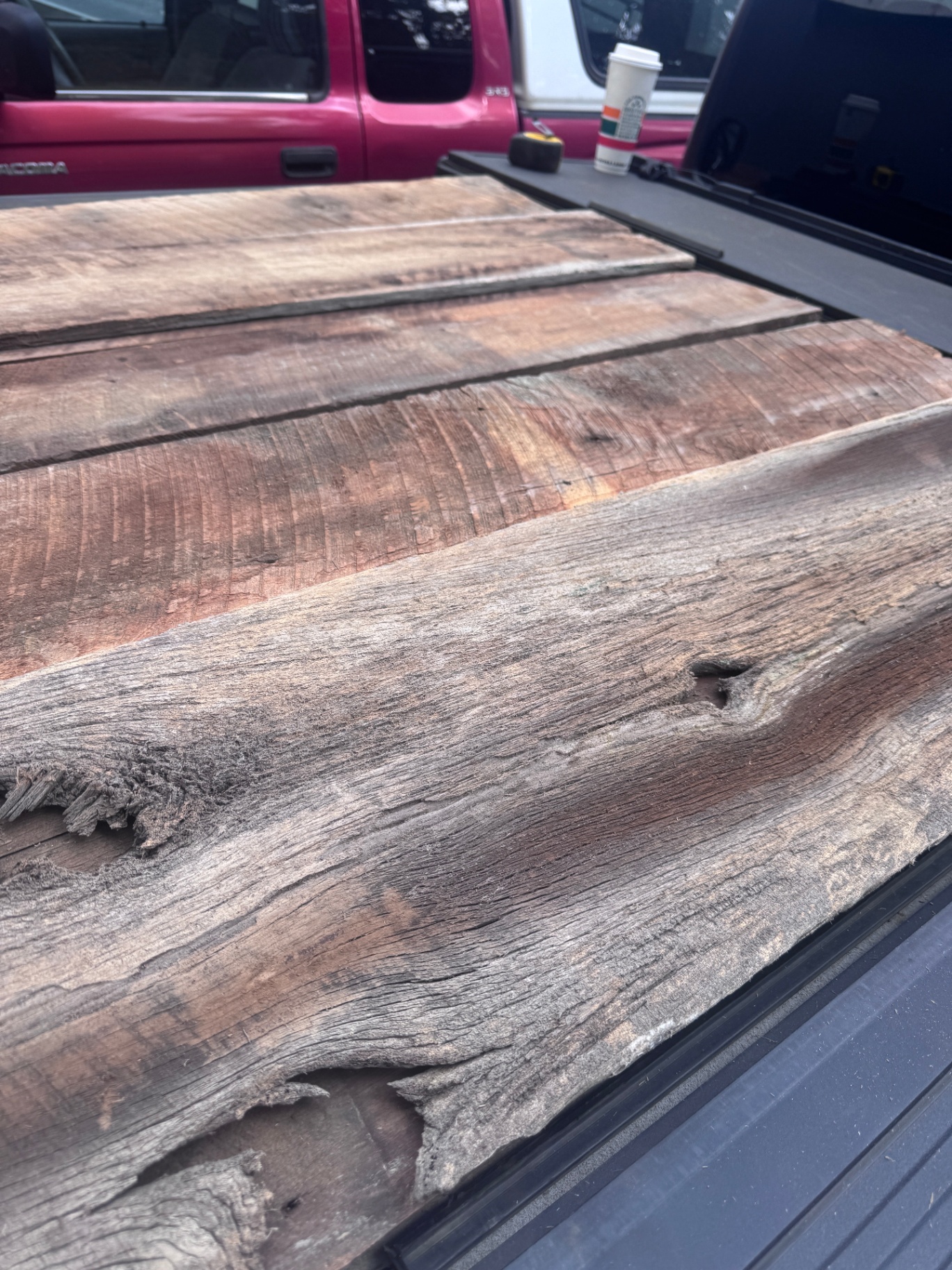 Close-up of warm brown and silver barnwood siding planks with deep grain