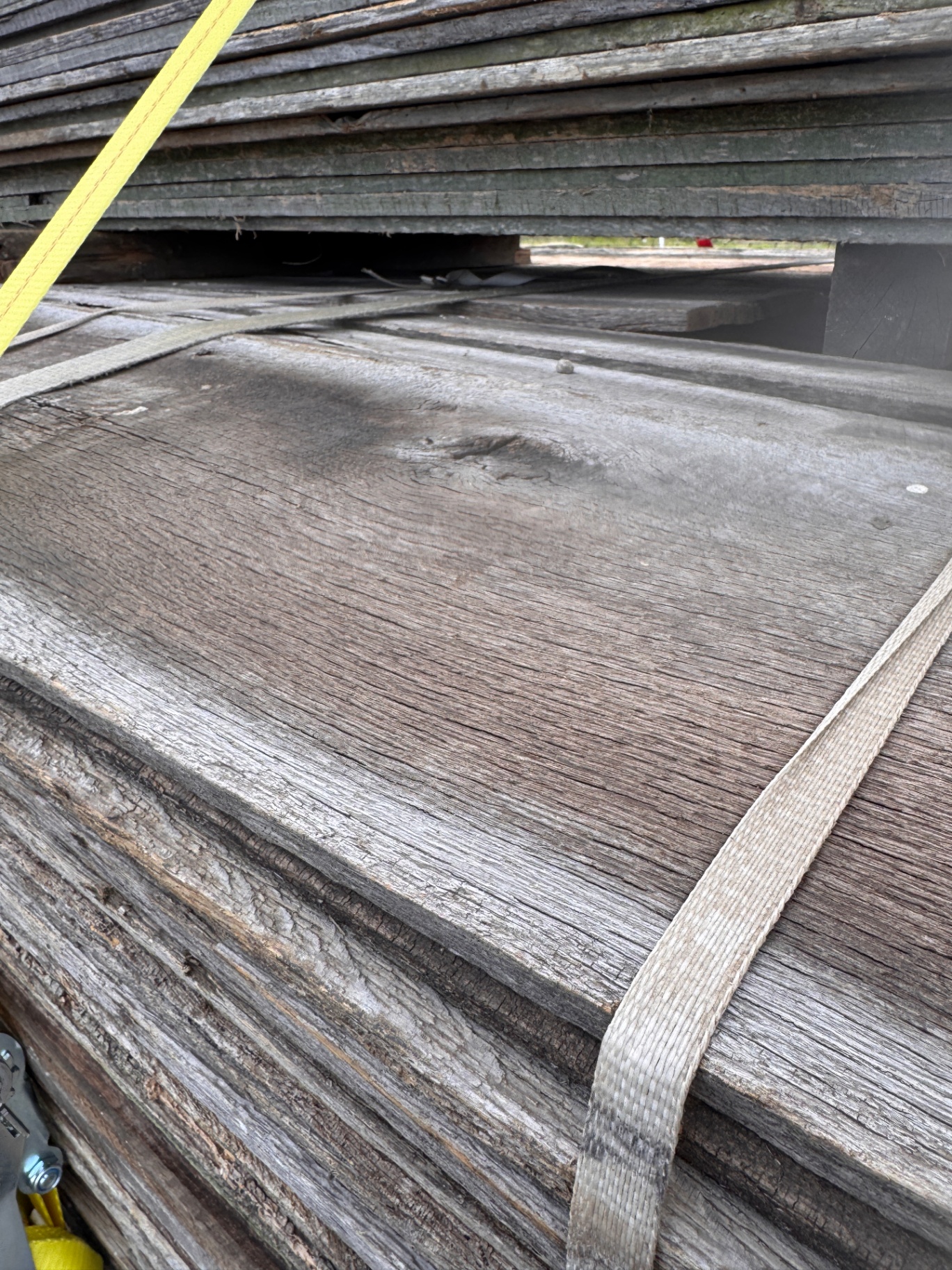 Silver-gray weathered barnwood siding board with natural knot and grain