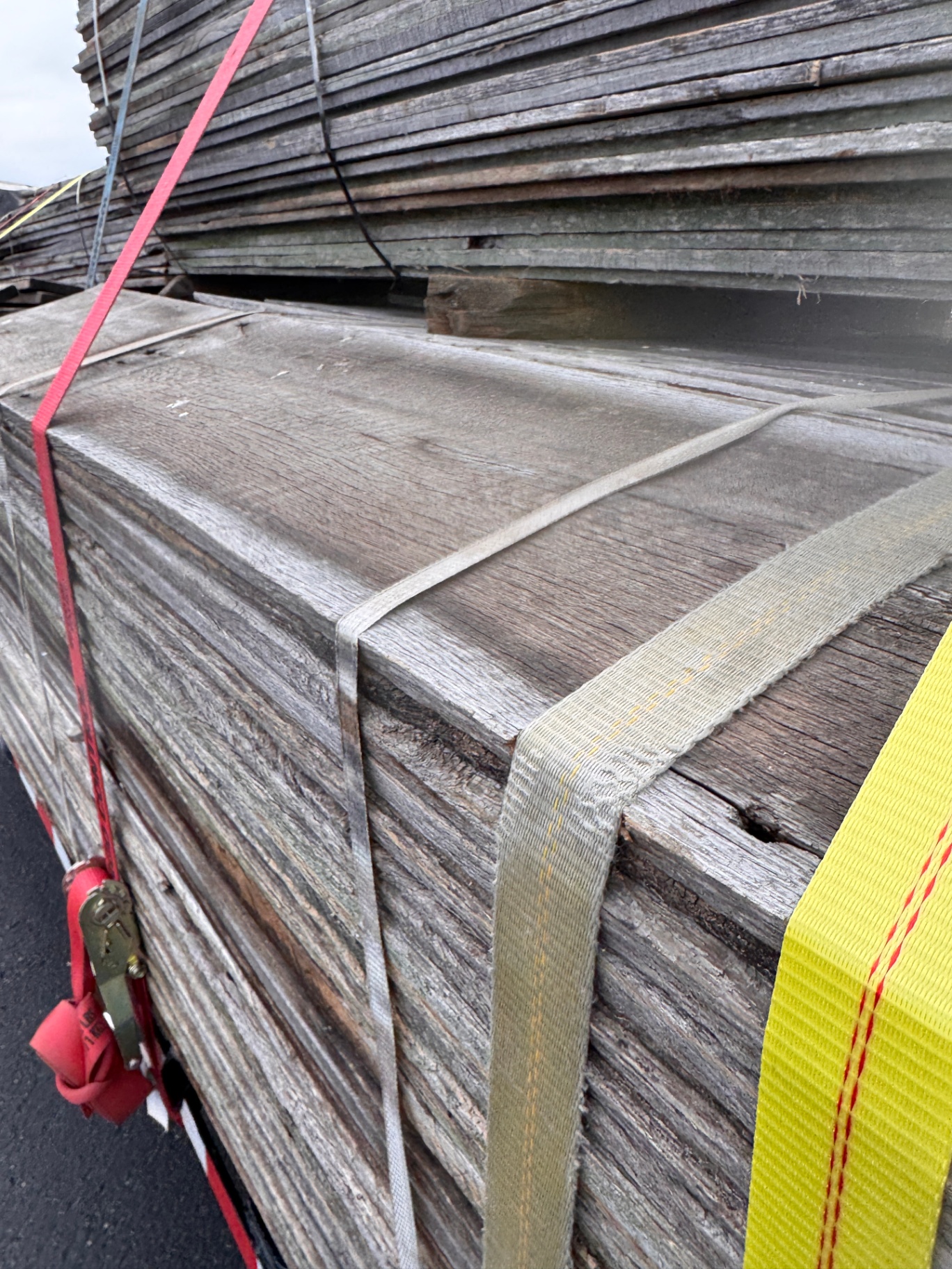 Bundled gray barnwood siding boards strapped and ready for delivery