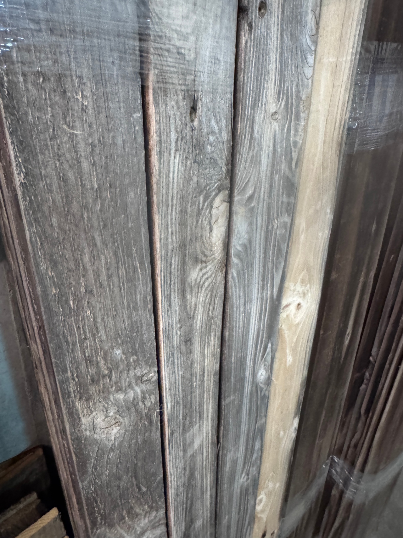 Detail of snow fencing planks with mixed grey and natural pine weathering