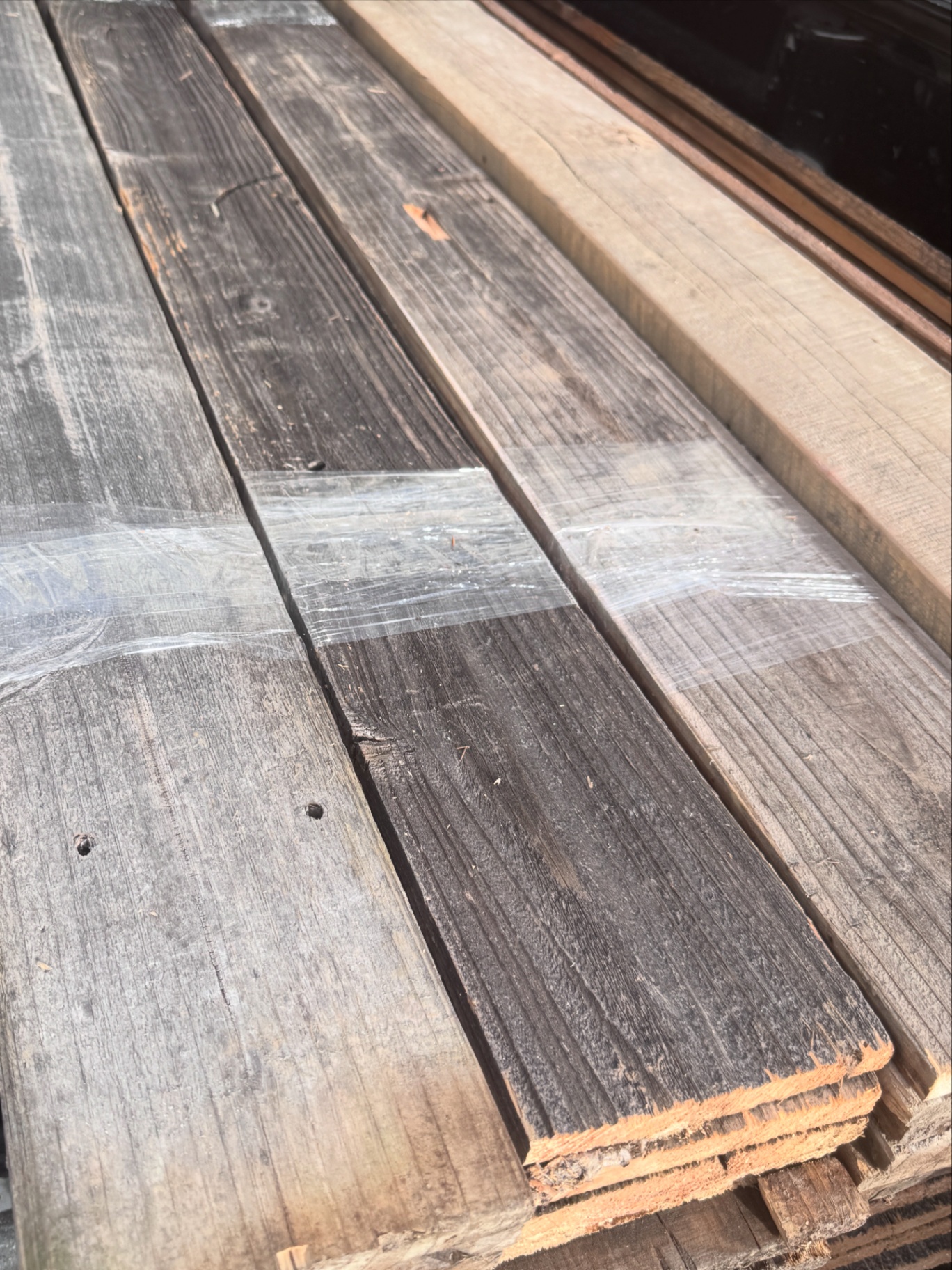 Wrapped snow fencing bundle showing mix of weathered grey and freshly cut edges