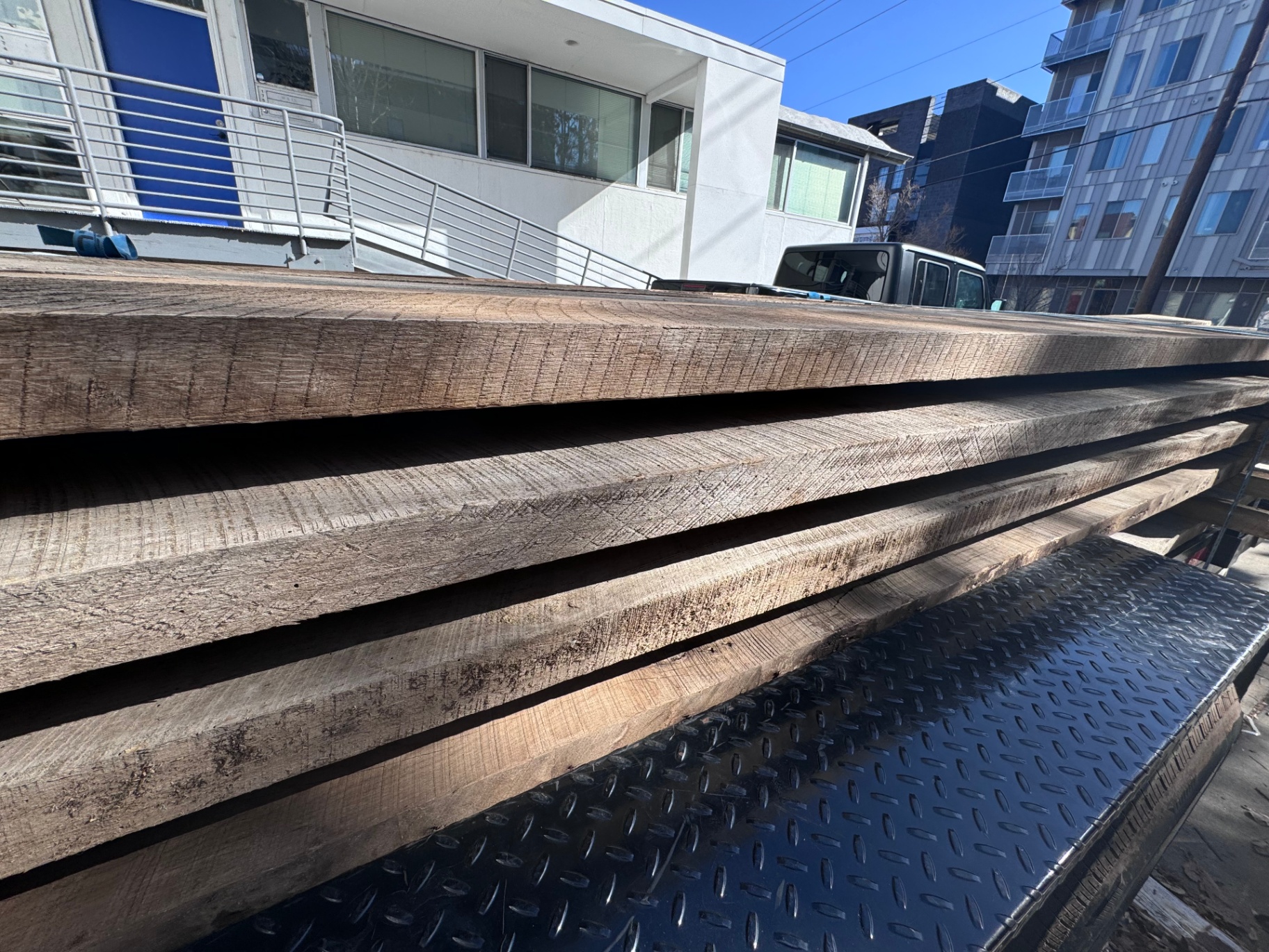 Side profile of stacked 2-inch reclaimed hardwood boards with weathered faces