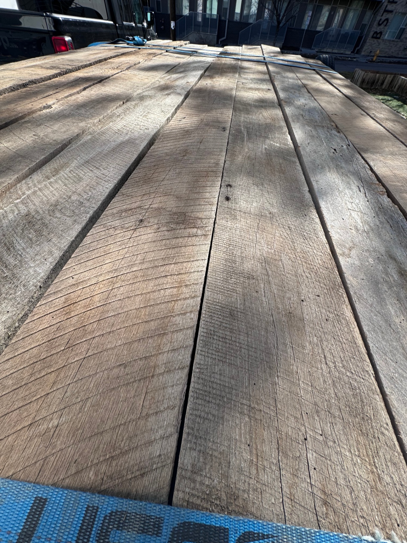 Top view of long reclaimed 2-inch hardwood planks with rough sawn texture