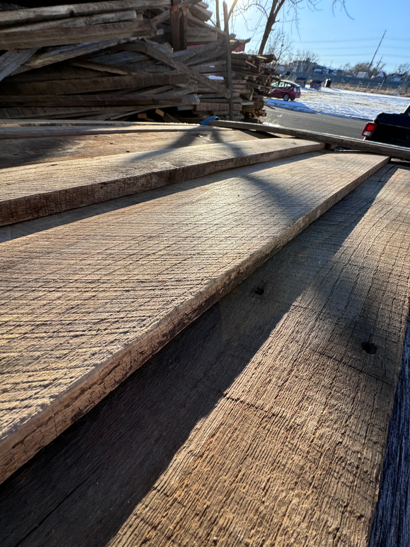 Close low-angle view across reclaimed 2-inch hardwood planks in warm afternoon light