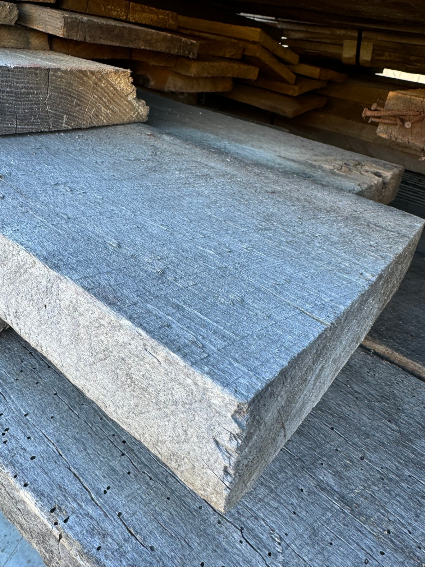 Single thick reclaimed 2-inch hardwood slab with silver-gray patina and worn edges